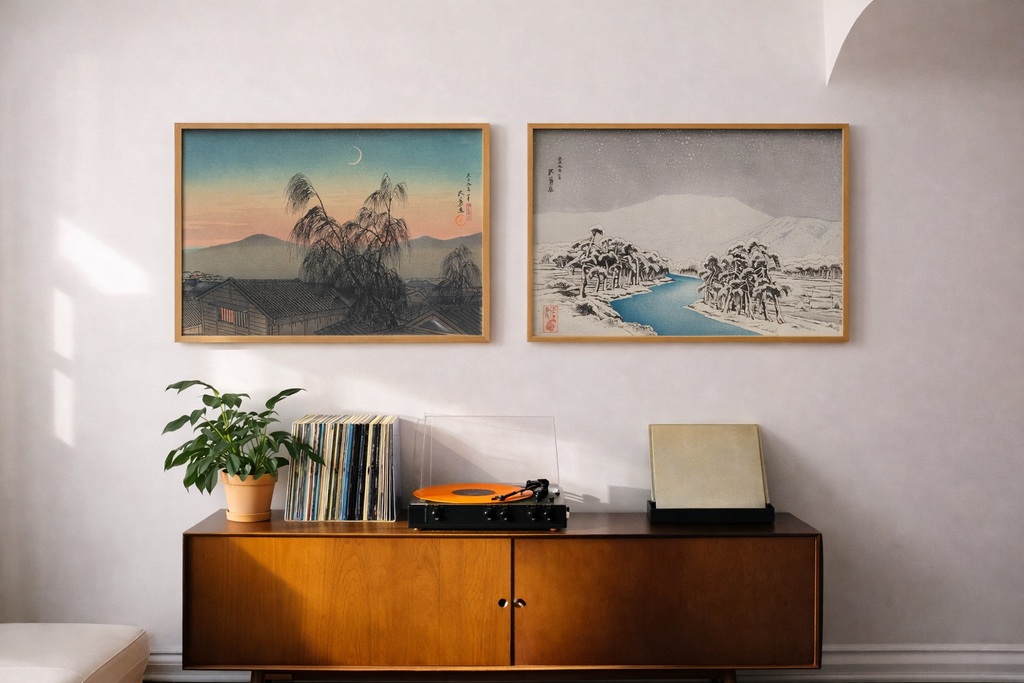 Two Japanese artworks hanging over top a turntable setup. "Mount Ibuki in Snow" by Hashiguchi Goyo, and "Evening Moon Over Kobe" by Hashiguchi Goyo.